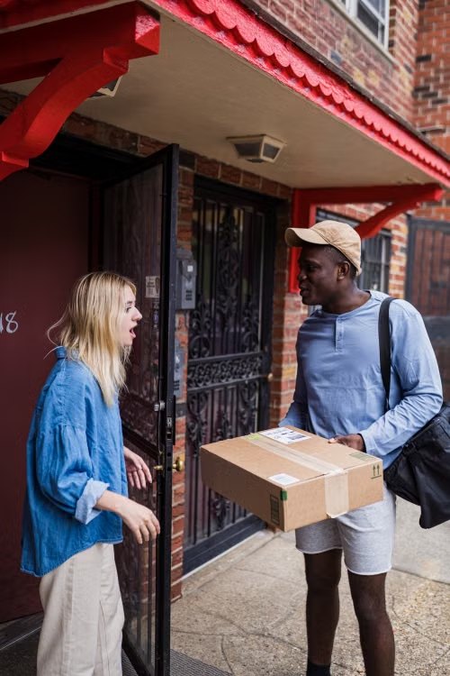 Courier handing a parcel to a customer